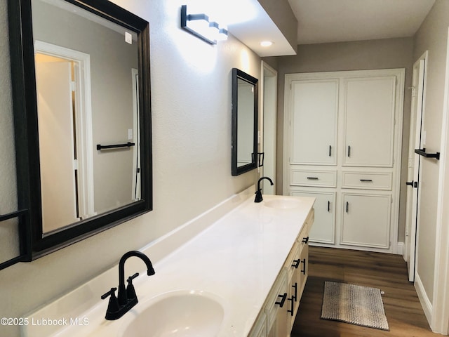 5712 73rd St, Lubbock, TX 79424 - full bathroom with double vanity and wood finished floors