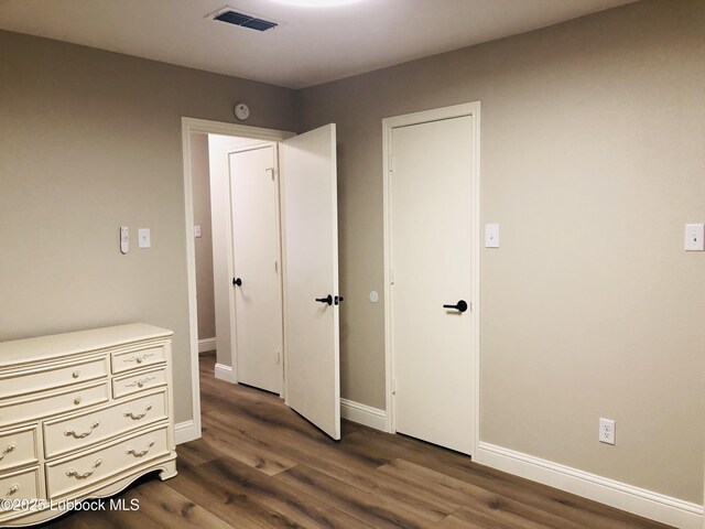 5712 73rd St, Lubbock, TX 79424 - unfurnished bedroom featuring dark wood finished floors and baseboards