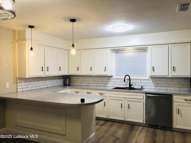 5712 73rd St, Lubbock, TX 79424 - kitchen with dishwashing machine, a sink, and white cabinets