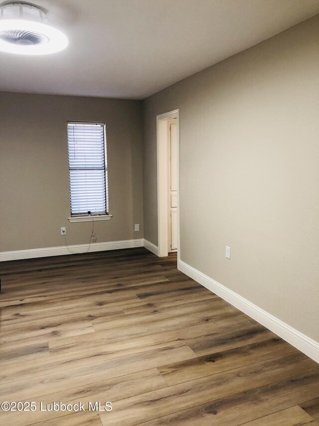 5712 73rd St, Lubbock, TX 79424 - empty room with baseboards and wood finished floors
