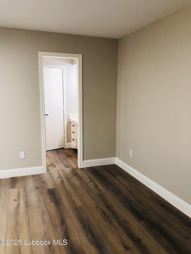 5712 73rd St, Lubbock, TX 79424 - empty room with baseboards and dark wood-style flooring