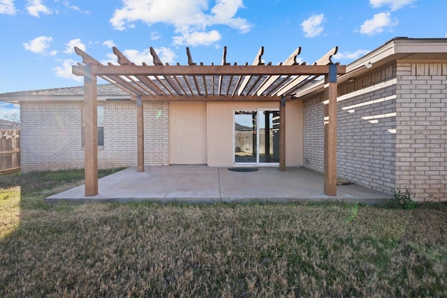 back of house featuring a pergola, a lawn, and a patio