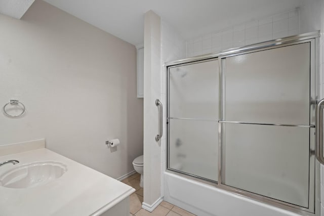 full bathroom with tile patterned flooring, vanity, enclosed tub / shower combo, and toilet