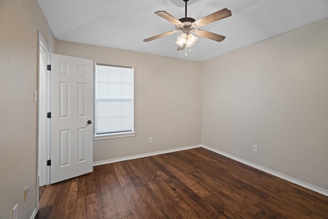 unfurnished room featuring ceiling fan and dark hardwood / wood-style flooring