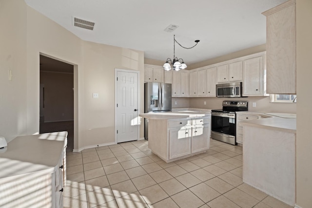 kitchen with light tile patterned floors, hanging light fixtures, stainless steel appliances, a center island, and a chandelier