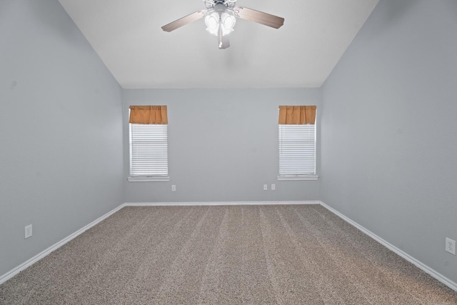 carpeted spare room with ceiling fan and lofted ceiling