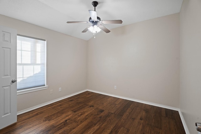 spare room with ceiling fan and dark hardwood / wood-style flooring