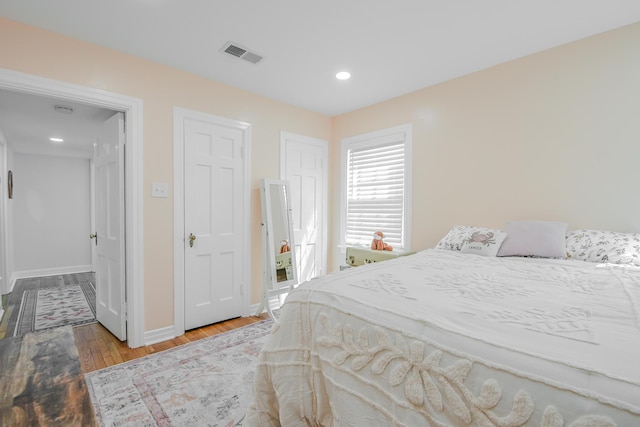 3123 22nd St, Lubbock, TX 79410 - bedroom featuring baseboards, recessed lighting, wood finished floors, and visible vents