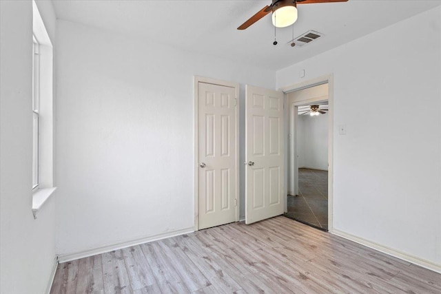 unfurnished bedroom with ceiling fan and light hardwood / wood-style flooring