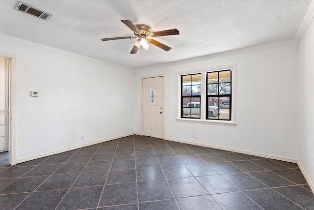 spare room featuring crown molding, ceiling fan, dark tile patterned flooring, and a textured ceiling