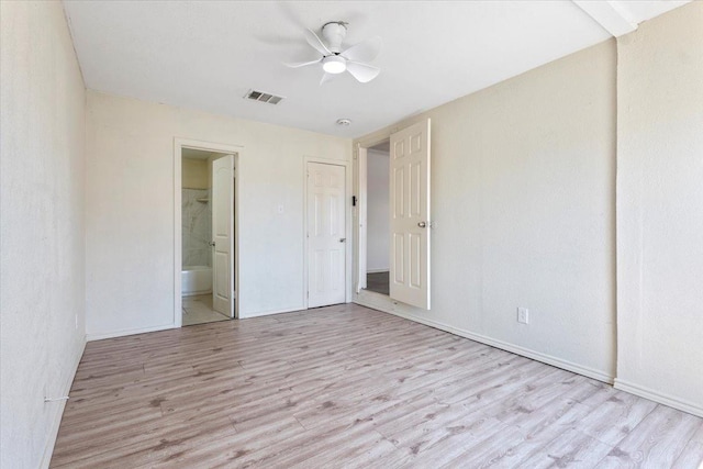 unfurnished bedroom featuring ceiling fan, connected bathroom, and light hardwood / wood-style floors