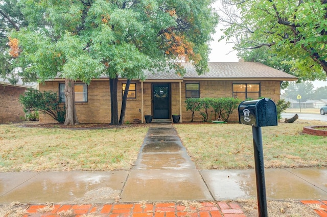 ranch-style house with a front lawn