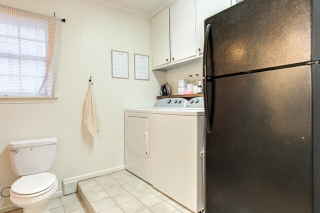 laundry room with washing machine and clothes dryer and light tile patterned floors