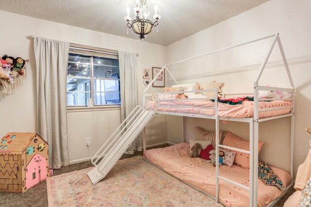 carpeted bedroom with a textured ceiling and a notable chandelier