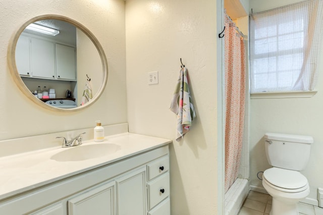 bathroom with vanity, curtained shower, tile patterned floors, and toilet