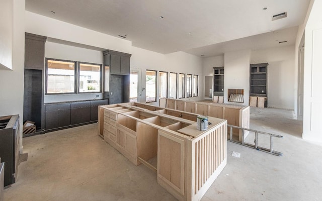 kitchen featuring light brown cabinetry and a kitchen island