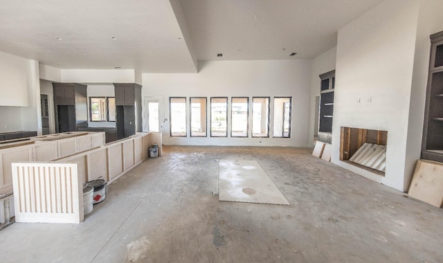 unfurnished living room featuring a multi sided fireplace