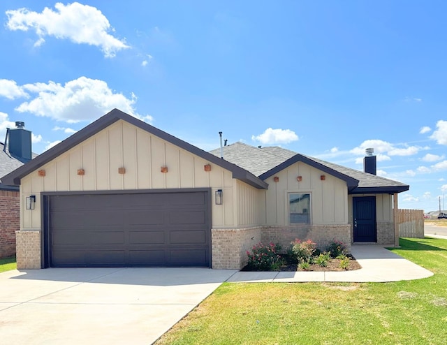 view of front of house with a garage and a front lawn