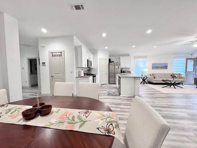 dining room featuring ceiling fan and light hardwood / wood-style flooring