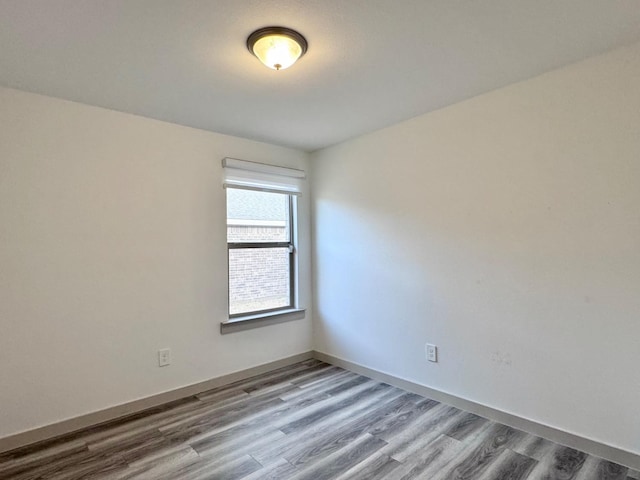 unfurnished room with hardwood / wood-style flooring