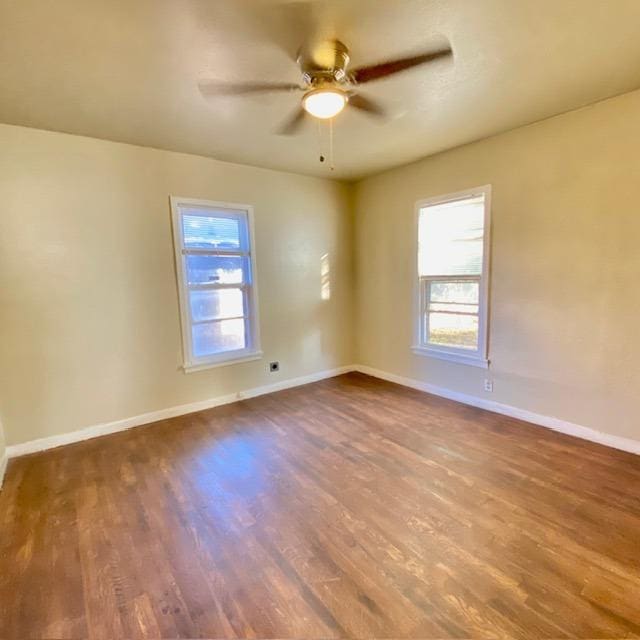 empty room with hardwood / wood-style flooring and ceiling fan