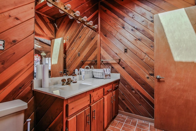 bathroom with wood walls and vanity