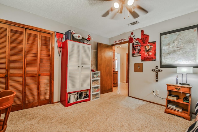 bedroom featuring two closets, ceiling fan, carpet flooring, baseboards, and visible vents