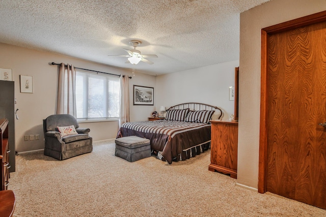 bedroom featuring baseboards, a ceiling fan, a textured ceiling, and carpet flooring
