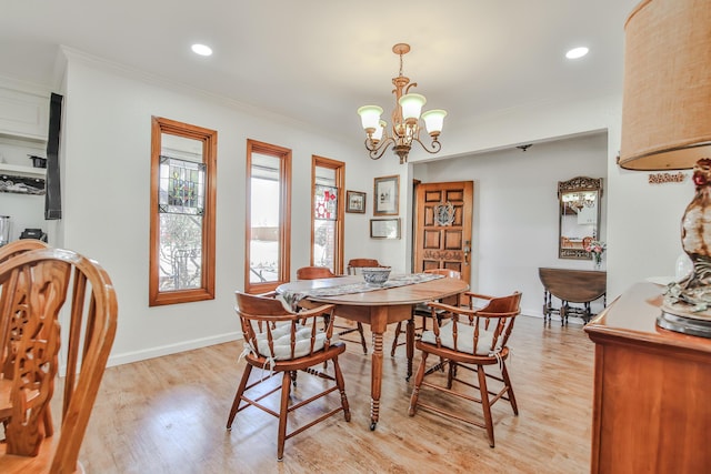 dining space with recessed lighting, light wood-style flooring, baseboards, a notable chandelier, and crown molding