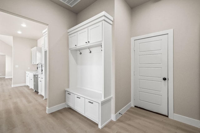 mudroom featuring sink and light hardwood / wood-style floors