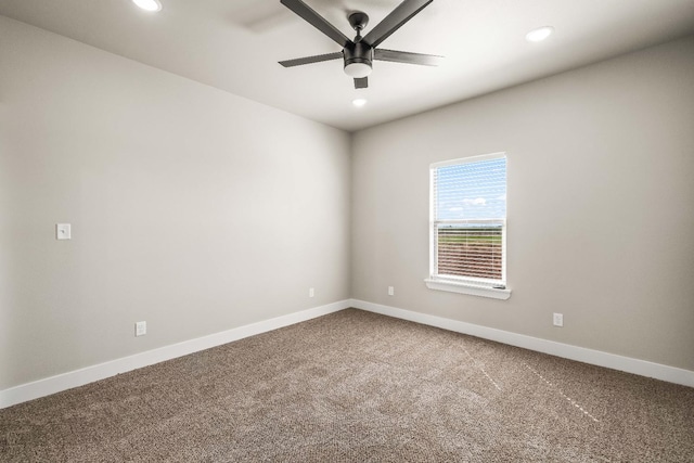 carpeted spare room featuring ceiling fan