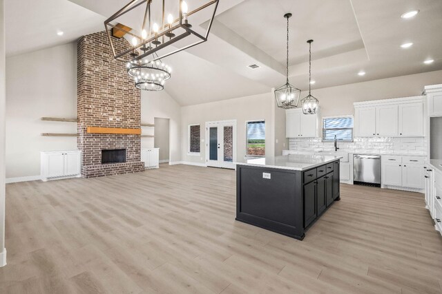 kitchen featuring white cabinetry, a center island, and dishwasher