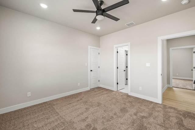 unfurnished bedroom with light colored carpet and ceiling fan