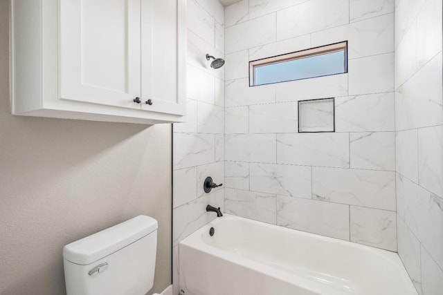 bathroom featuring toilet and tiled shower / bath combo