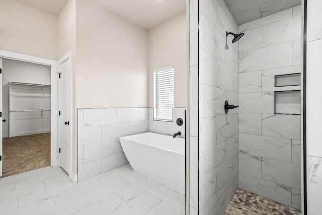 bathroom with tile walls and plus walk in shower