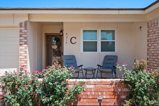 entrance to property with a garage and a porch