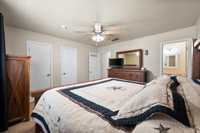 carpeted bedroom with ceiling fan and a textured ceiling