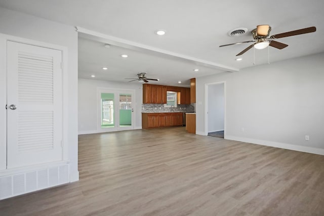 5217 45th St, Lubbock, TX 79414 - unfurnished living room featuring a ceiling fan, recessed lighting, light wood-style flooring, baseboards, and a sink