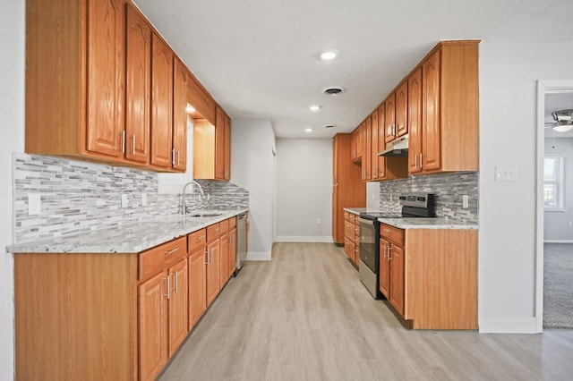 5217 45th St, Lubbock, TX 79414 - kitchen featuring stainless steel electric stove, under cabinet range hood, light wood-style flooring, baseboards, and recessed lighting