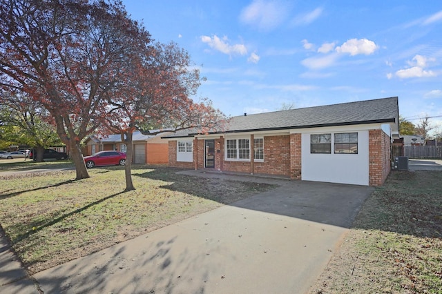 5217 45th St, Lubbock, TX 79414 - ranch-style house featuring driveway, brick siding, a front yard, and central AC unit