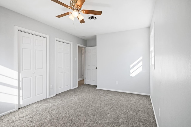5217 45th St, Lubbock, TX 79414 - unfurnished bedroom with carpet flooring, baseboards, multiple closets, and ceiling fan