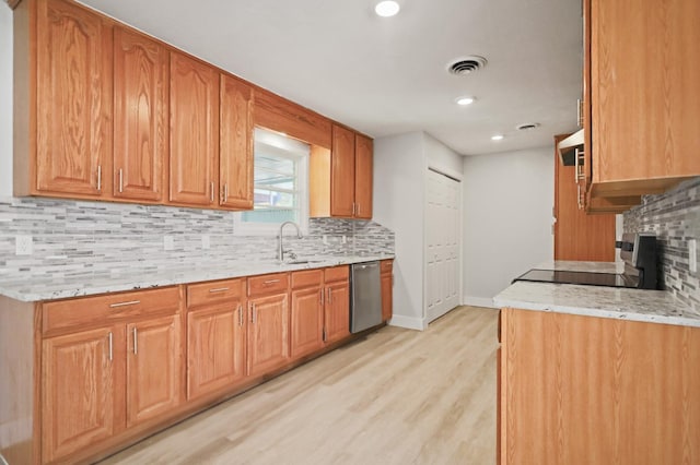 5217 45th St, Lubbock, TX 79414 - kitchen with stainless steel appliances, tasteful backsplash, light wood finished floors, light stone countertops, and recessed lighting