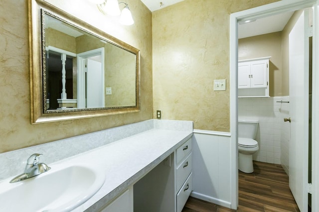 bathroom with vanity, hardwood / wood-style flooring, and toilet