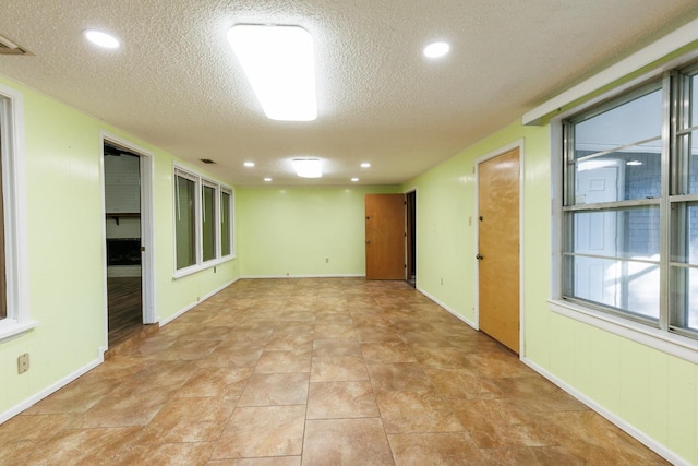 unfurnished room featuring a textured ceiling