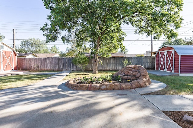 view of yard with a storage shed and a patio