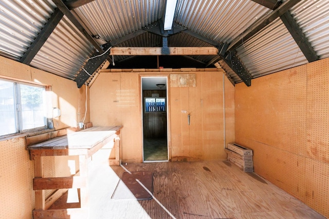 misc room with lofted ceiling with beams and hardwood / wood-style floors