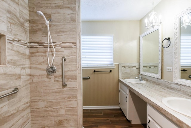 bathroom with vanity, a chandelier, and a wealth of natural light