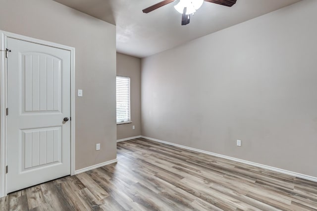 spare room featuring ceiling fan and light wood-type flooring