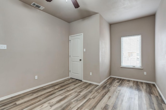 empty room featuring hardwood / wood-style flooring and ceiling fan