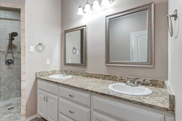 bathroom with vanity and a tile shower